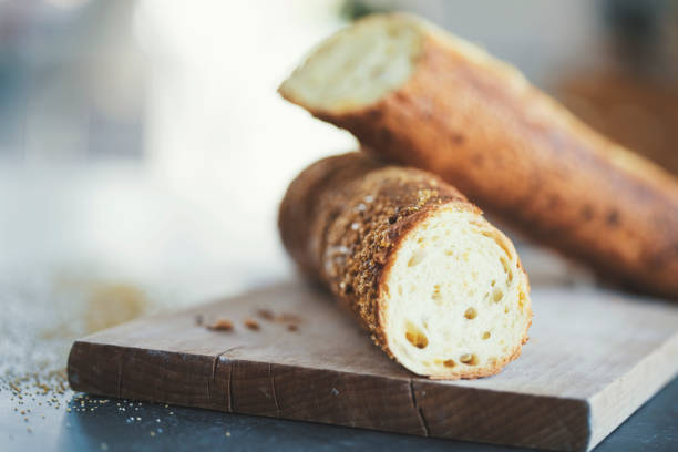 Close up of halved baguette on cutting board
