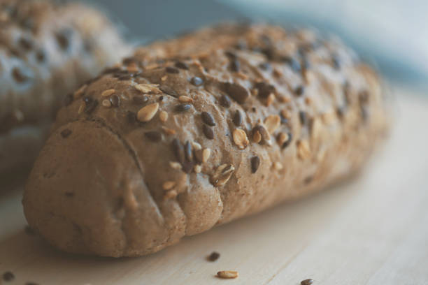 Brown integral loaf of bread rolls with various seeds.