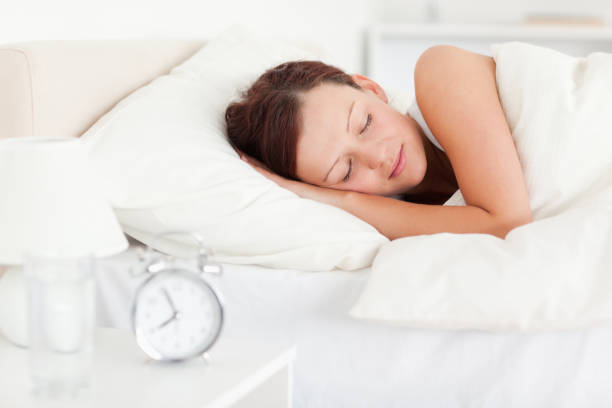 istock Redhaired woman lying in bed 825075100