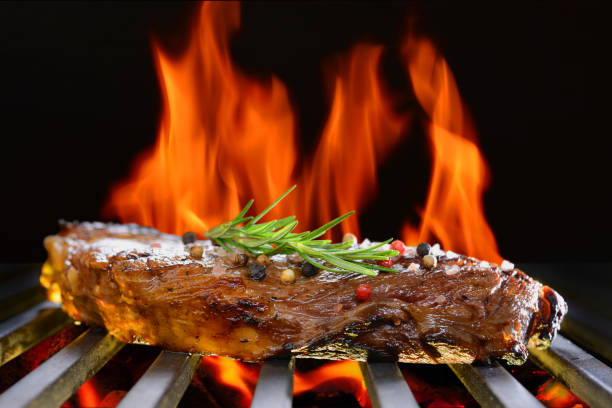 istock Grilled beef steak on the flaming grill 825076306