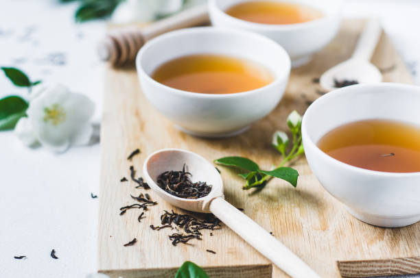 istock Green tea with a jasmine in white cups 825078962
