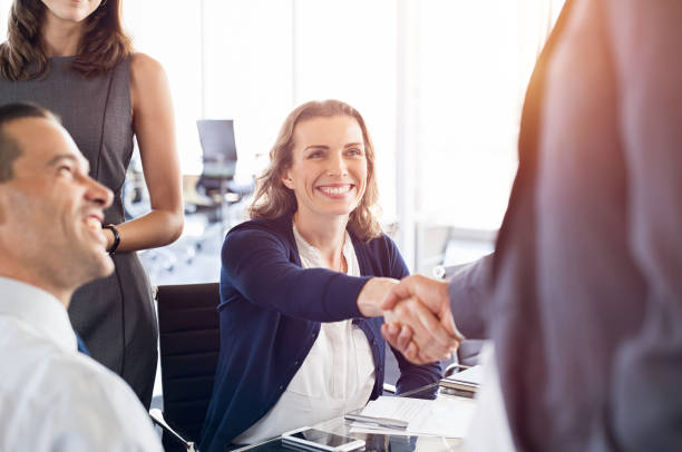 istock Mature businesswoman shaking hands 825082466
