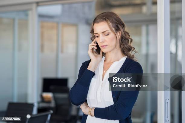 Serious Businesswoman Talking On Phone Stock Photo - Download Image Now - Using Phone, Serious, Women