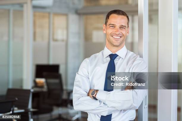 Smiling Businessman At Office Stock Photo - Download Image Now - Men, Businessman, Real Estate Agent