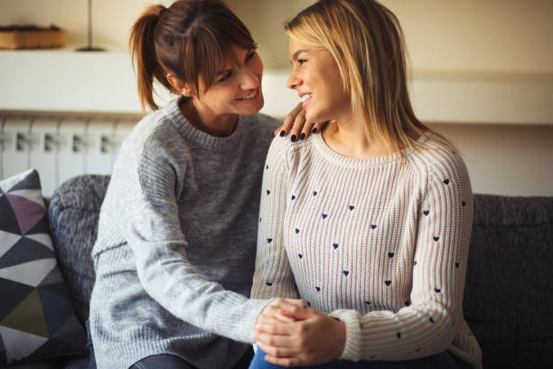 istock Smiling affectionate lesbian couple relaxing at home and communicating. 825086244