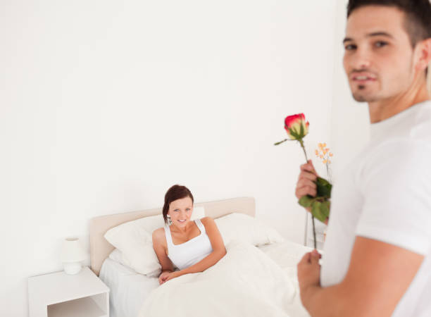 istock Cute guy with a rose for his girlfriend 825087534