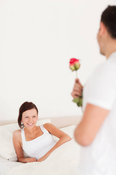istock Handsome guy with a rose and his girlfriend 825087602
