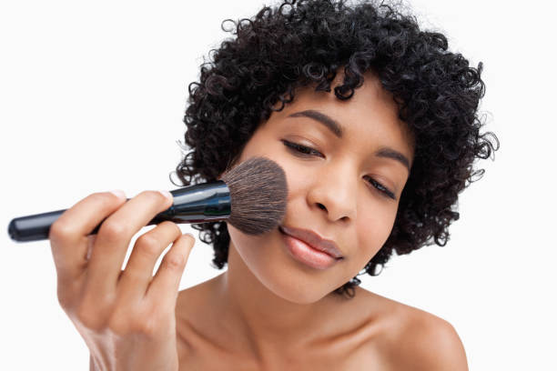 istock Teenager precisely applying powder with her black brush 825091424