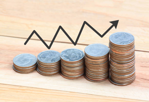 istock Silver coin stack and arrow line in business growth concept on wood floor. 825091952