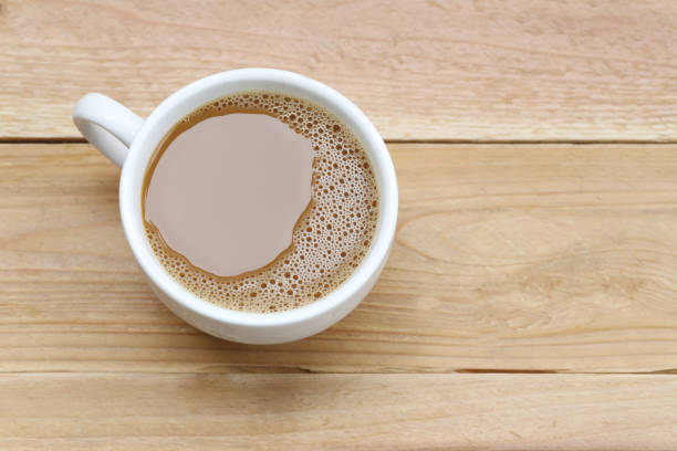 istock Hot coffee in a white Coffee cup on wooden table at coffee shop. 825092564