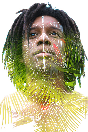 Double exposure portrait of an african american young man combined with the photograph of the palm tree