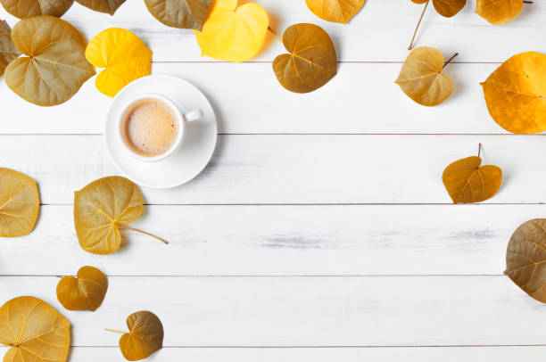 istock hot coffee with heart shaped autumn leaf 825093042