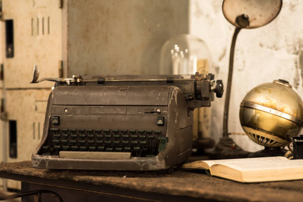 istock Typewriter and old books on the desk 825093636