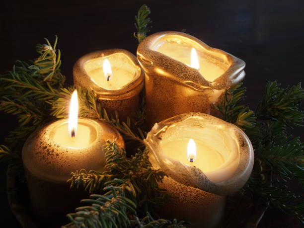 istock Four golden candles and pine tree branches forming a Christmas decoration on a table, Melbourne 2016 825095646