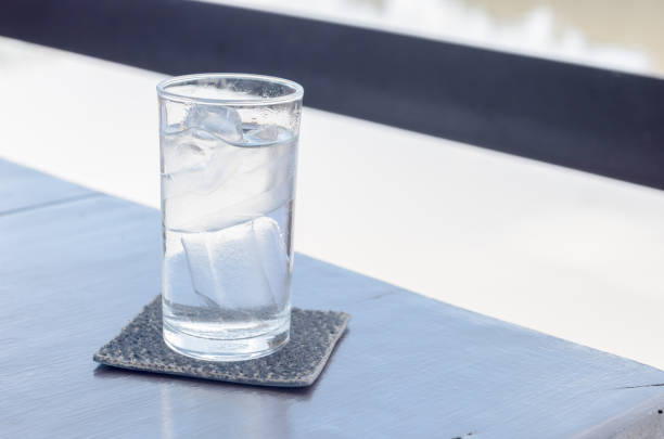 pure water with ice in glass on table