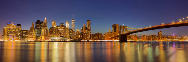 istock New York City skyline and Brooklyn Bridge at night 825096176