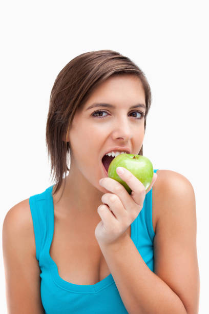 istock Attractive teenager eating a green apple 825100162