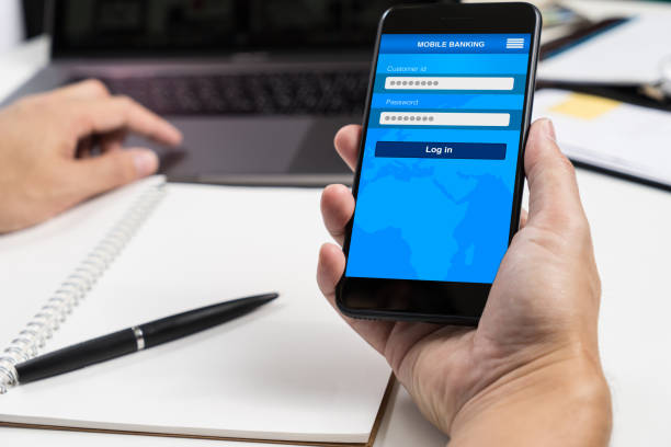 istock Asian man hand using smart phone to connect to Mobile banking app 825108400
