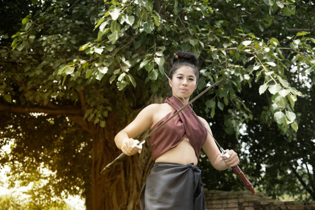 istock Pretty Asian woman posing in Thai ancient warriors dresses. 825112770