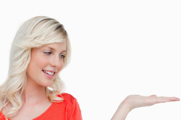 istock Smiling woman looking at her hand palm up 825113090