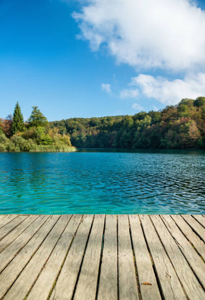 istock Old wooden pier at sunny day 825117212