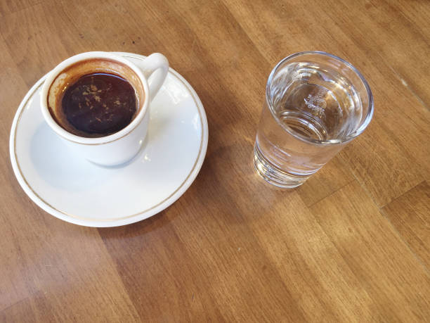 istock cup of coffee and water on table 825118750