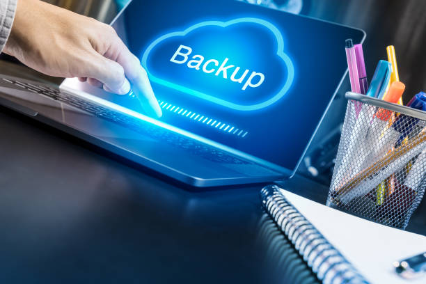 Businessman hand using modern laptop with Cloud Backup concept Businessman hand using modern laptop with Cloud Backup concept backup stock pictures, royalty-free photos & images