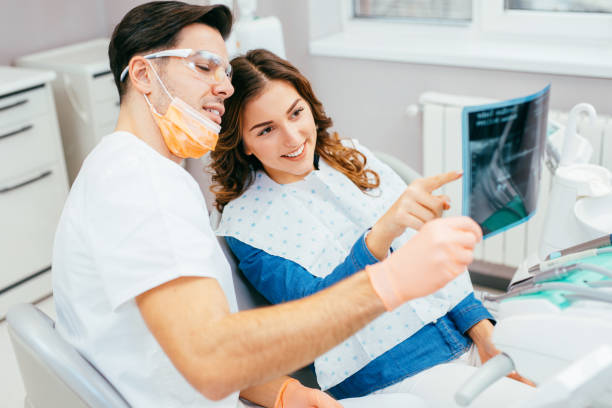 istock Dentist showing a patient her x-ray 825121842