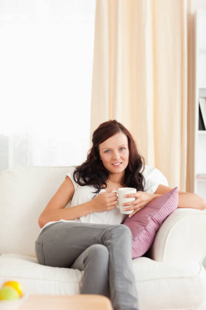 istock Woman holding a cup looking into the camera 825122466