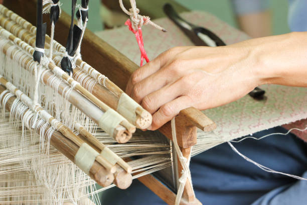 istock Close Up Of Asian Man Hand Weaving 825125784