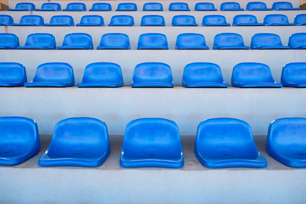 istock Amphitheater of dark blue seats abstract background 825128338