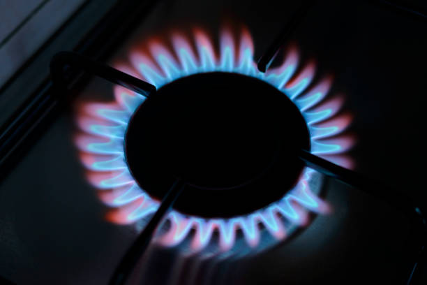 istock Blue and orange flames on a gas stove burner 825130394