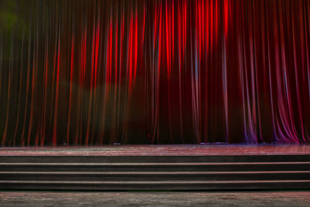 istock Red curtains and wooden stage. 825133212