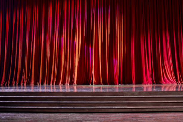 istock Red curtains and wooden stage. 825134500
