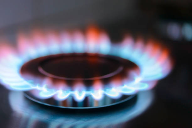istock Blue and orange flames on a gas stove burner 825135606
