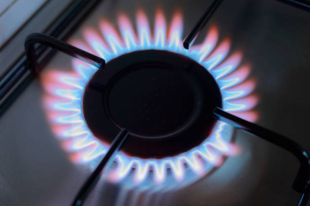 istock Blue and orange flames on a gas stove burner 825138510
