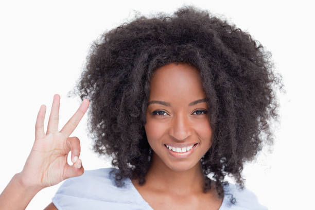 istock Young woman making the OK sign while smiling 825138512