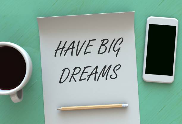 istock Have Big Dreams, message on paper, smart phone and coffee on table, 3D rendering 825142624