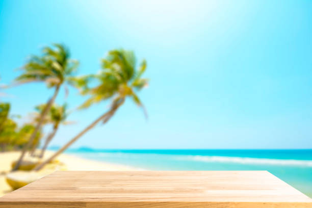 istock Empty Wooden table for display product and blurry beautiful beach in background 825146296