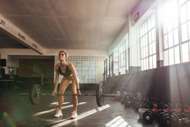 istock Young woman working out at the gymnasium. 825146984