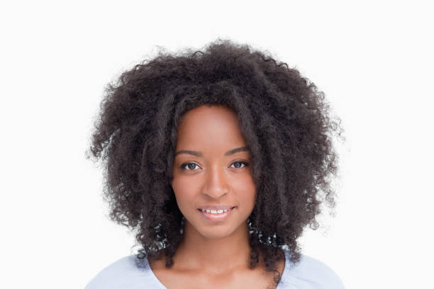 istock Young woman with curly hairstyle standing upright 825148086