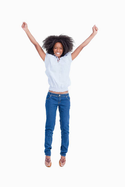 istock Young woman beaming while raising her arms above the head 825150396