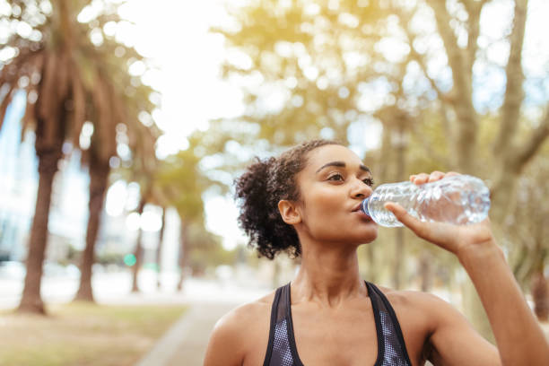 istock Athlete drinking water during morning jog 825150482