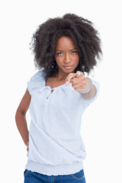 istock Young serious woman with curly hairstyle pointing her finger 825150656