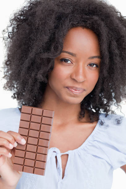 istock Young woman holding a delicious chocolate bar 825150746