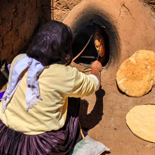 istock Moroccan woman making bread - khubz 825154064
