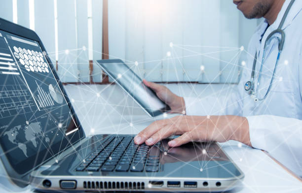 istock Medicine doctor working with computer notebook and digital tablet at desk in the hospital 825155164