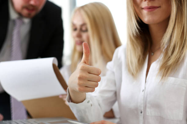 istock Female hand showing OK or approval sign with thumb up 825156004