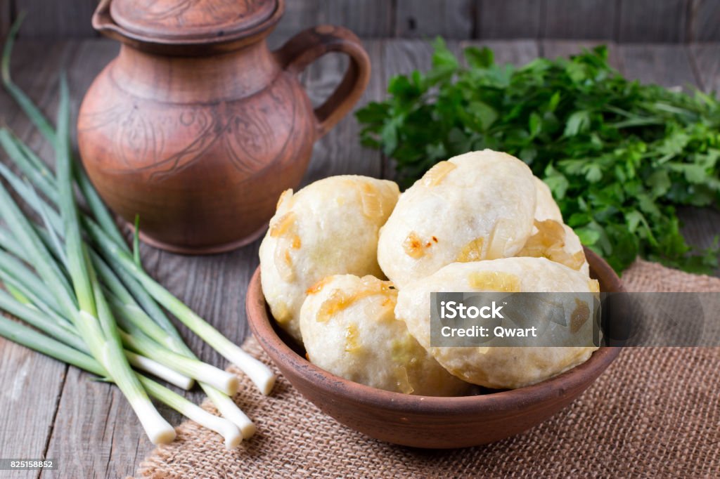 Traditional vareniki in a bowl on a wooden table. Ukrainian food Boiled Stock Photo