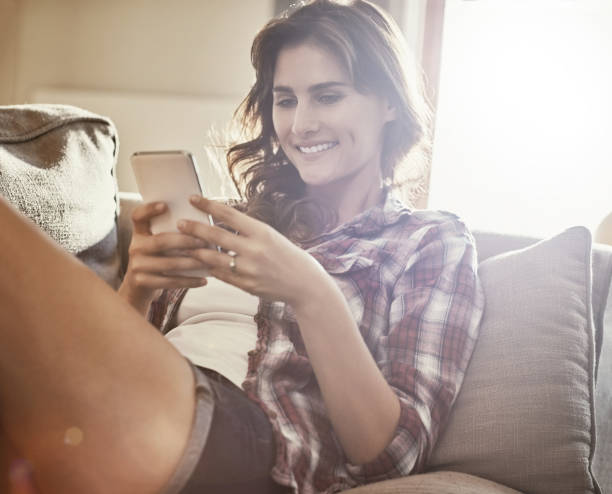 istock Sharing her sofa day with social media 825159398